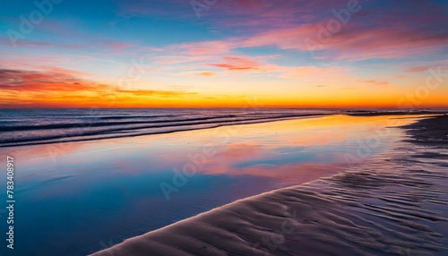 beach sunset with vibrant hues reflecting on calm waters serene mood