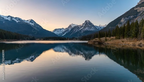sunset in the mountains at a calm lake reflecting the peaks