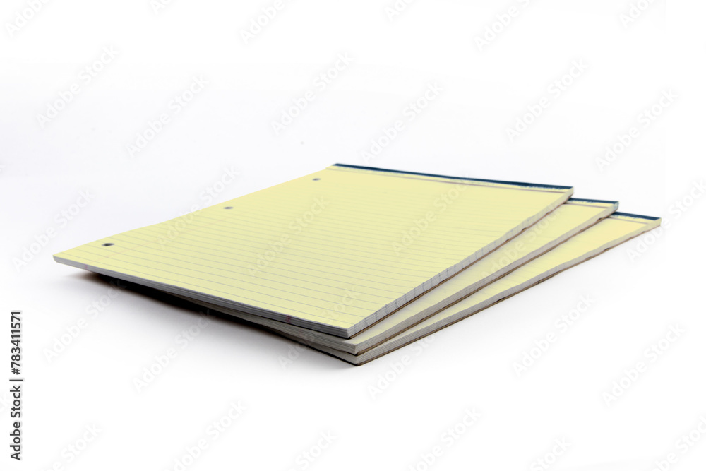 pads of yellow three hole punched legal note paper isolated on white pads of yellow three hole punched legal note paper isolated on white