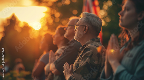 A poignant scene of veterans placing their hands over their hearts as the national anthem plays, gathered around a flagpole. The setting sun casts a soft glow, enhancing the emotio