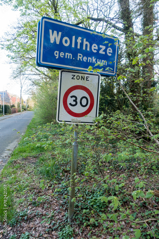 Place name sign for the village of Wolfheze, municipality of Renkum (also speed limit of 30 km per hour)