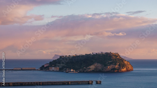 Golden sunset over the sea at the coast of Gulf of Naples at Campi Flegrei with island, Pozzuoli, Campania, Italy