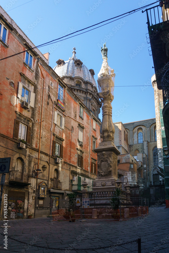 Street view of old town in Naples with San Gennaro obelisk in Piazza Cardinale Sisto Riario Sforza, Naples, Campania, Italy