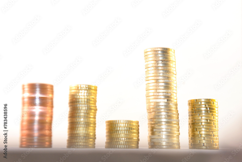 Stacks of gold coins of different levels, on a white background. Concept of financial growth and investment success. Stacks of gold coins of different levels, on a white background. Concept of financial growth and investment success.