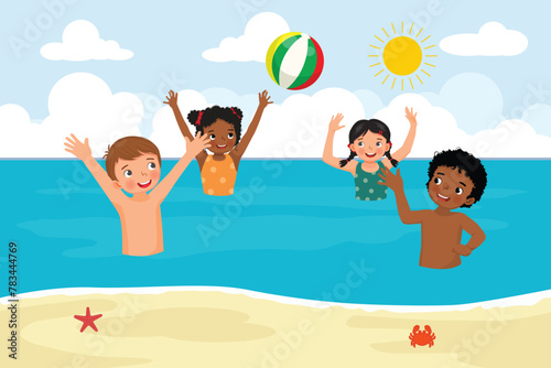 Group of multi-ethnic kids having fun in the sea playing beach ball at summer time