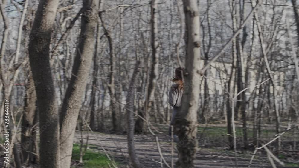Attractive girl with an athletic build running among the trees in the park Attractive girl with an athletic build running among the trees in the park