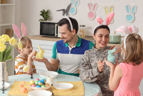 Female soldier with her fam...