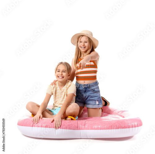 Cute little kids sitting on inflatable mattress and pointing and pointing at something on white background