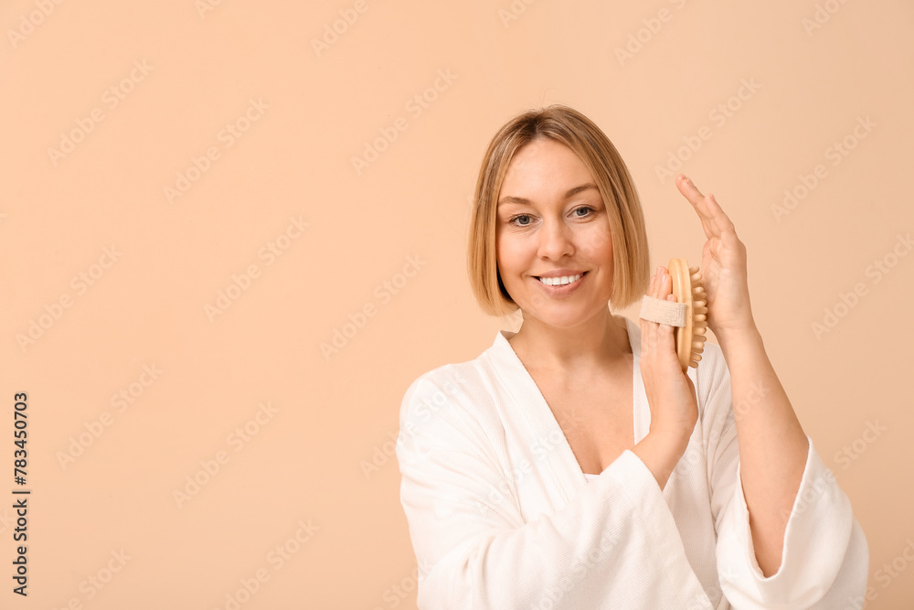 Beautiful young woman with body massage brush on beige background Beautiful young woman with body massage brush on beige background