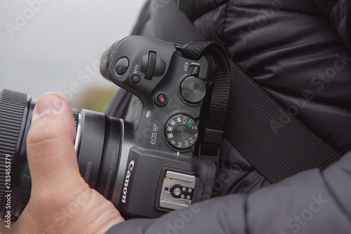 close up of a person holding a camera