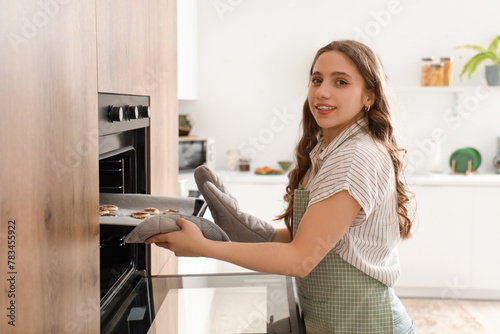 Young woman baking cookies ...
