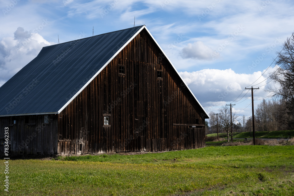 Rustic wood barn in rural America, agricultural background landscape
Rustic wood barn in rural America, agricultural background landscape