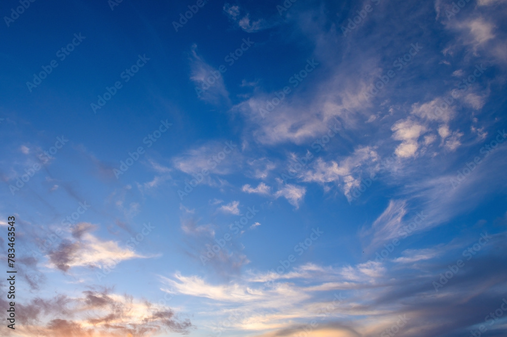 Pastel light cirrus clouds in the blue sky during dawn sunset sunrise, sky background