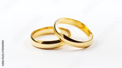 Romantic concept. Two gold wedding rings isolated on white background.