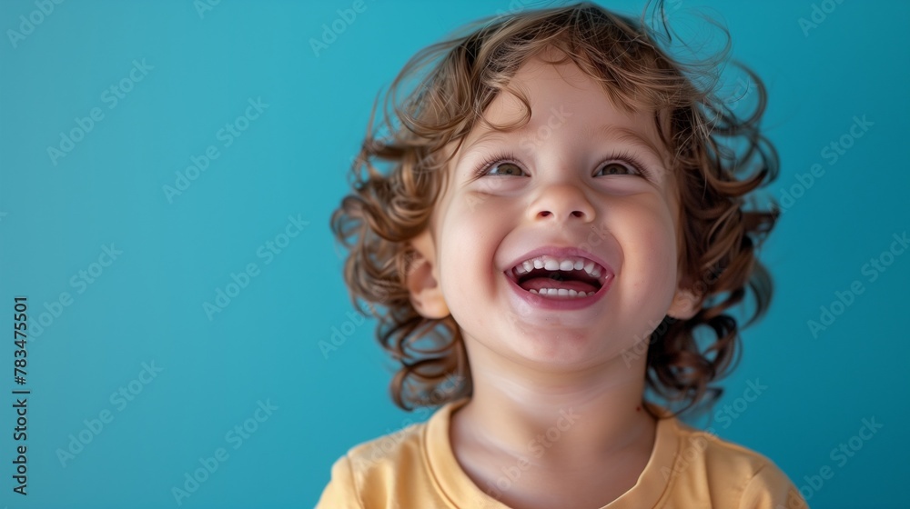A little boy smile laughing happiness wearing yellow t shirt isolate color background A little boy smile laughing happiness wearing yellow t shirt isolate color background