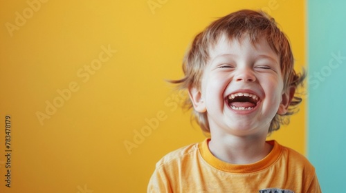 A little boy smile laughing happiness wearing yellow t shirt isolate color background