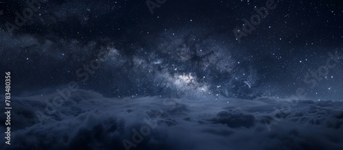 The night sky is filled with twinkling stars and fluffy clouds, creating a serene and beautiful scene