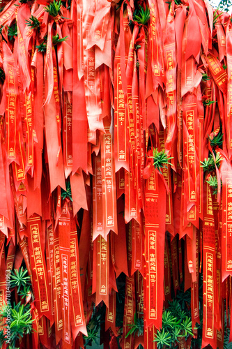 Red ribbons for blessing hang from a tree at Hanshan Temple in Suzhou, Jiangsu province, China