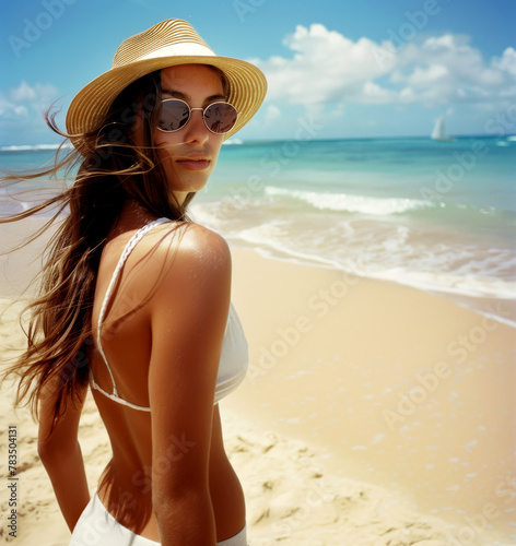 Cool breeze and sunshine: young woman in panama hat enjoys beach day