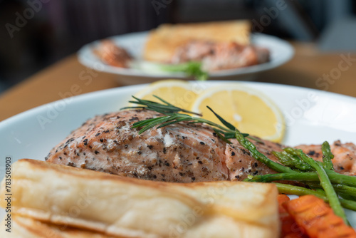 Close up, Salmon Steak with Butter Toast Ready to eat on a wooden table.