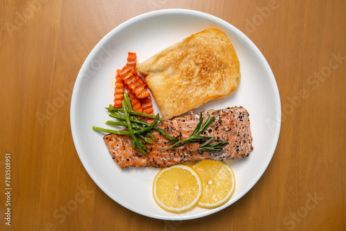 Salmon Steak with Butter Toast Ready to eat on a wooden table. Top view.