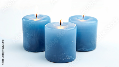 Three wide blue candles close together on white background