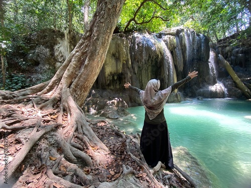 person sitting on the tree, mata jitu waterfalls photo