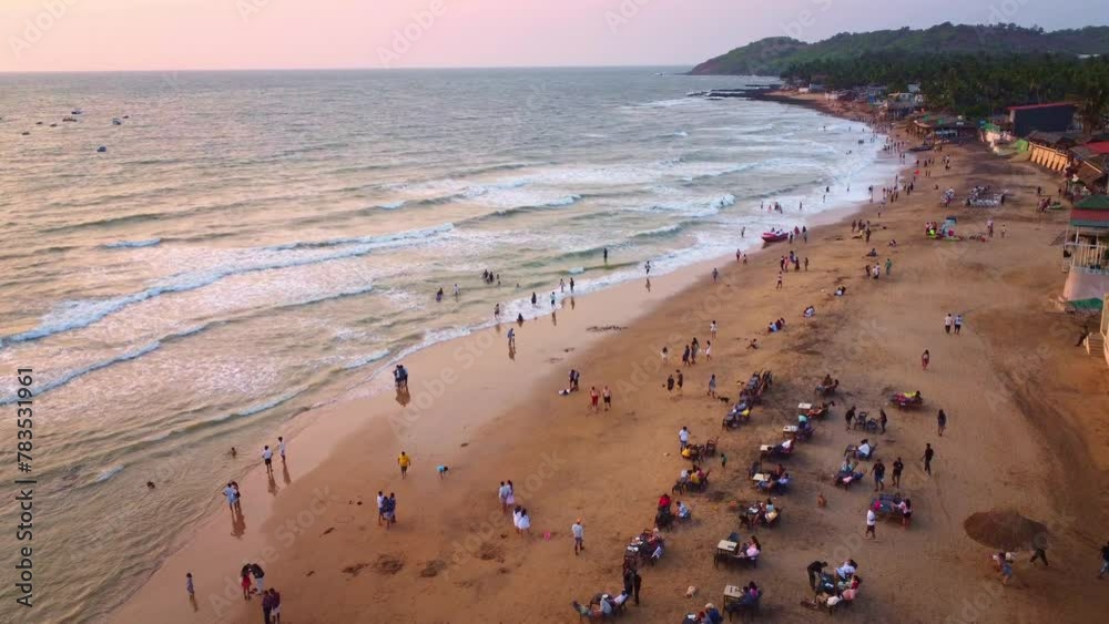 Drone shot of people enjoying and relaxing at goa beach at evening at Sunset. Drone shot of people enjoying and relaxing at goa beach at evening at Sunset.