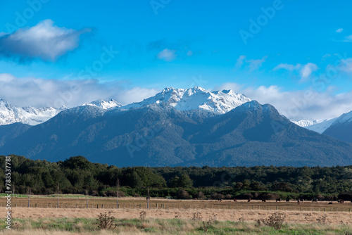 Photograph of the agricultural paddocks and mountain view while driving from Te Anau in Fiordland to Manapouri on the South Island of New Zealand photo