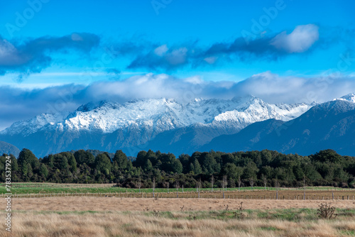 Photograph of the agricultural paddocks and mountain view while driving from Te Anau in Fiordland to Manapouri on the South Island of New Zealand photo