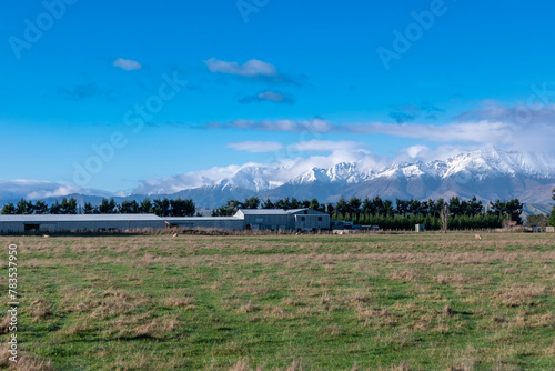 Photograph of the agricultural paddocks and mountain view while driving from Te Anau in Fiordland to Manapouri on the South Island of New Zealand