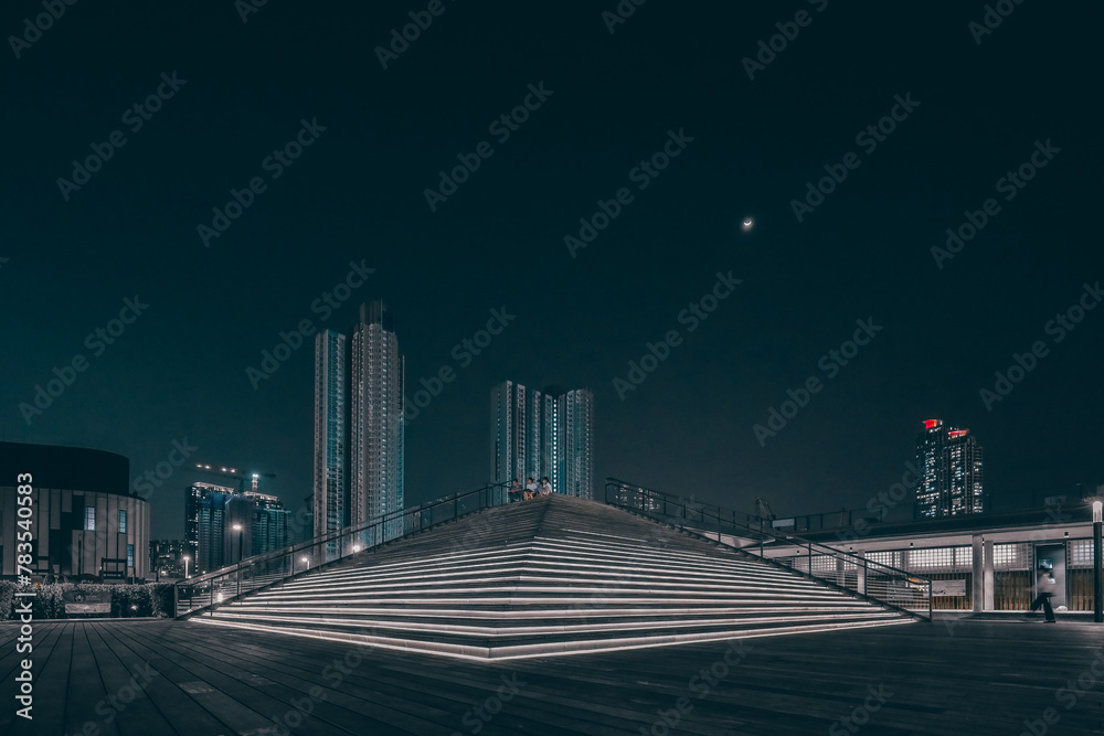 Fototapeta premium night landscape of the kai tak avenue park with apartment April 12 2024