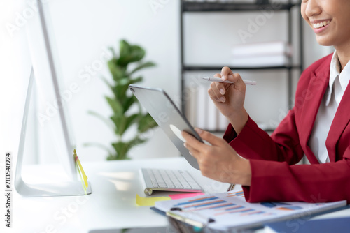 Businesswoman using digital tablet with stylus pen. Corporate efficiency and digital workflow concept photo
