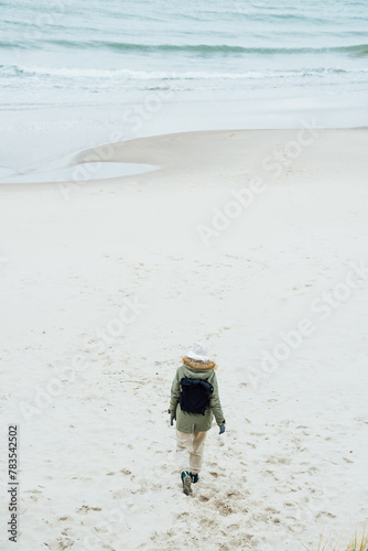 Woman standing on the empty beach (ID: 783542502)