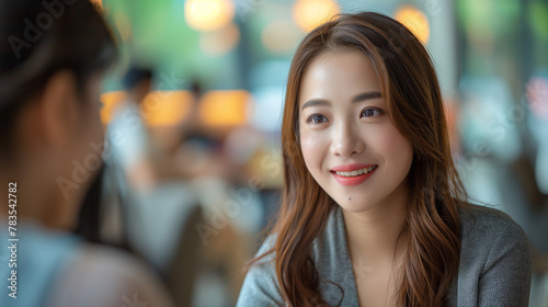 Portrait young Asian woman interviewer and interviewee shaking hands for a job interview .Business people handshake in modern office. Greeting deal concept.