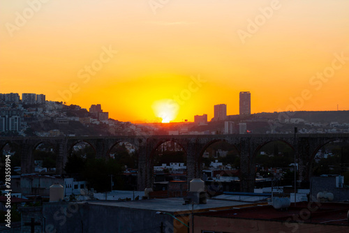 beautiful sunrise in the city center seen from a viewpoint overlooking a beautiful arched aqueduct