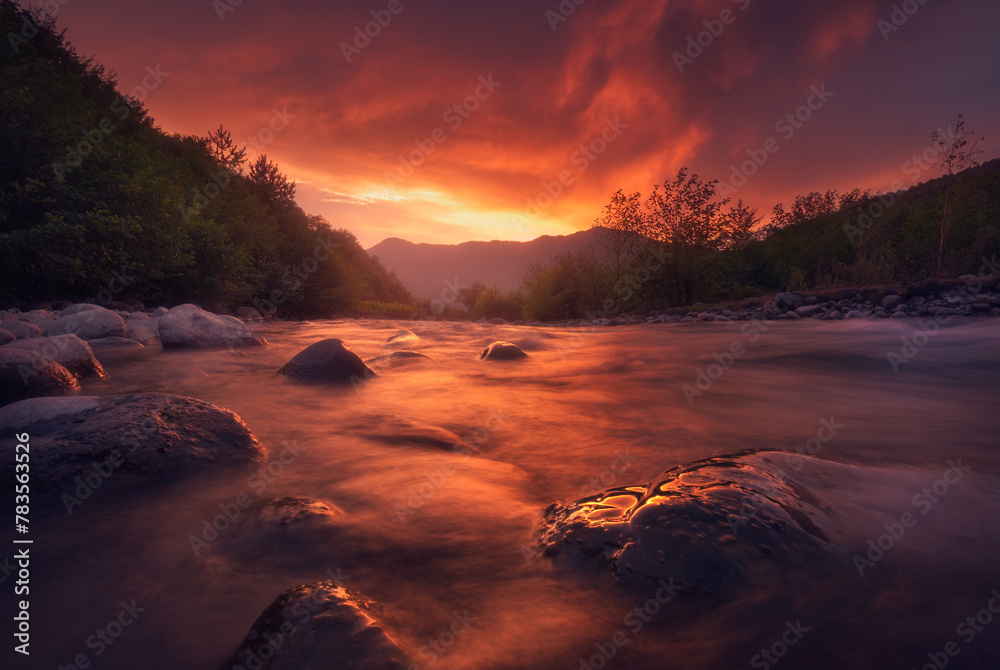 fast mountain river flowing In sunset time