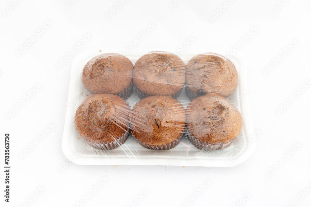 Fototapeta premium Muffins cakes package on white isolated background