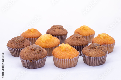 Fresh tasty chocolate muffins cakes on white isolated background.