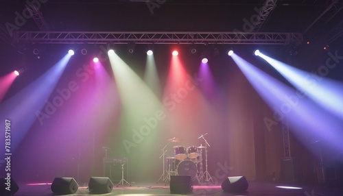 A stage is lit up with colored spotlights in bright colours 