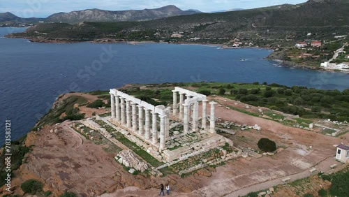 Temple of Poseidon is one of the most famous monuments in Greece , perched on a rocky promontory overlooking the Egean Mediterranean  sea , Cape Sounion - drone aerial view of Unesco Heritage world  photo