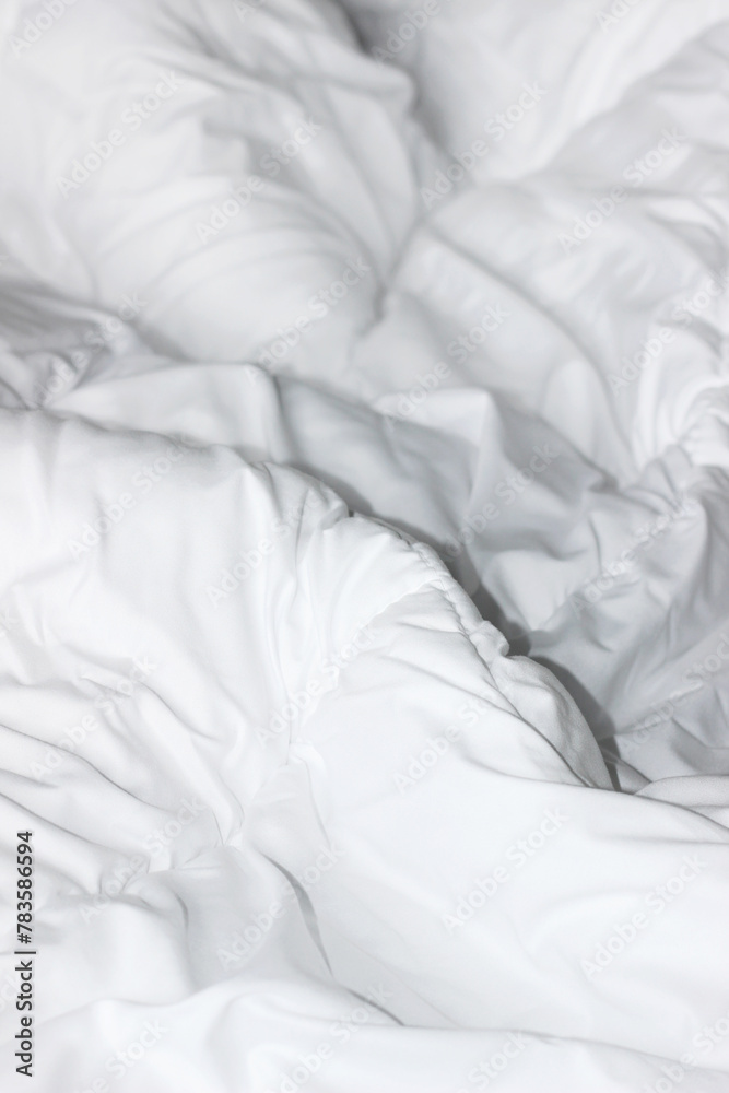 Obraz premium Unmade Bed with Fluffy White Duvet Blanket. Hotel Comfort Sleep Concept. 