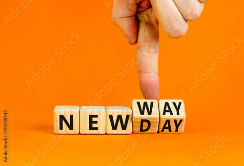 New day and way symbol. Concept word New day New way on beautiful wooden cubes. Beautiful orange table orange background. Businessman hand. Business new day and way concept. Copy space.