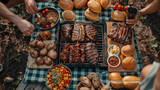 Assortment of delicious meat, ribs bursting with flavor, and an array of baked potatoes and sides on picnic blanket.
