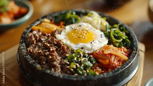 A bowl of bimbimbap with egg and vegetables