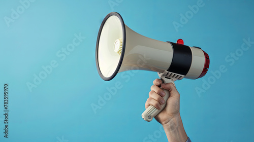 Megaphone for loud announcement in hand on isolated blue background