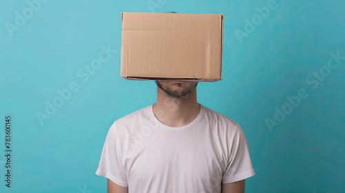 Young man in a white T-shirt with a cardboard box on his head on pastel blue background