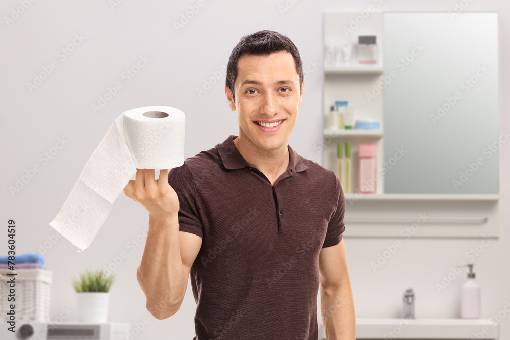 Guy holding a roll of toilet paper Guy holding a roll of toilet paper