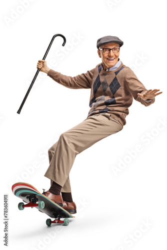 Happy elderly man riding a skateboard and holding a cane