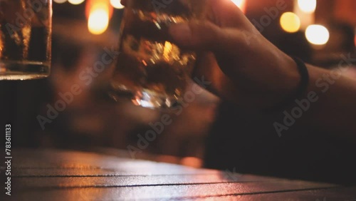 close up of Man poured beer into a glass and took a sip thinking looking pensive businessman in cafe relax take break photo